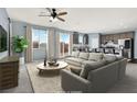 Virtually staged living room with open floor plan and kitchen view at 5921 Roaring Canyon Ct, Las Vegas, NV 89139