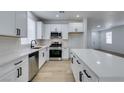 Bright kitchen featuring white shaker cabinets, quartz countertops, and stainless steel appliances at 5934 Clear Valley Ave, Las Vegas, NV 89142