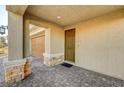 Front entrance with brown door and stone accents at 5969 Viscaya Grove St, Las Vegas, NV 89118