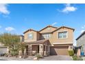 Two-story house with tan exterior, shutters, and attached garage at 6332 Ava Ridge Ave, Las Vegas, NV 89141