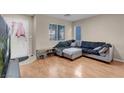 Living room with gray sectional sofa and wood floors at 6461 Karlsen Ct, Las Vegas, NV 89122