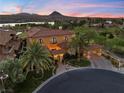 Beautiful two-story home showcases a tile roof, porte-cochere, well-manicured landscaping, and a circular driveway at 17 Rue Du Rivoli Pl, Henderson, NV 89011