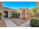 Front courtyard entry with gravel and a rocking chair at 2039 Colvin Run Dr, Henderson, NV 89052