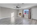 Bright living room with fireplace, hardwood floors, and ceiling fan at 213 Valley Forge Ave, Henderson, NV 89015