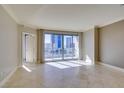 Bright living room featuring tile floors and access to a balcony with city views at 222 Karen Ave # 1604, Las Vegas, NV 89109