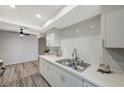 White kitchen with subway tile backsplash and stainless steel sink at 3152 S Eastern Ave # 26, Las Vegas, NV 89169