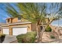 Two-story home with a three-car garage and well-maintained landscaping for enhanced curb appeal at 3349 Morning Amber St, North Las Vegas, NV 89032