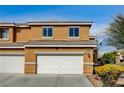 Two-story home with a two-car garage and desert landscaping at 3349 Morning Amber St, North Las Vegas, NV 89032
