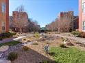 Beautiful courtyard view with manicured landscaping, walking paths and buildings in the background at 38 E Serene Ave # 134, Las Vegas, NV 89123