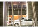 Contemporary building entrance with gray automobile parked in covered valet area at 4381 W Flamingo Rd # 2903, Las Vegas, NV 89103