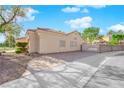 Back exterior view of the house with a side gate and driveway at 4509 Crimson Leaf Dr, Las Vegas, NV 89130