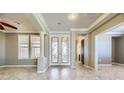Bright entryway with double doors, tile floors, and a view into the living room at 4750 Fiore Bella Blvd, Las Vegas, NV 89135