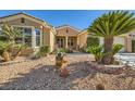 Tan house with palm trees and desert landscaping in front at 4750 Fiore Bella Blvd, Las Vegas, NV 89135