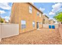 The backyard features low maintenance gravel with a block wall fence at 5555 Sun Temple Ave, Las Vegas, NV 89139