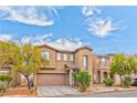 Inviting two-story home boasting desert landscaping, a two-car garage, and a charming entry at 5555 Sun Temple Ave, Las Vegas, NV 89139