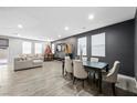 Spacious living room with a large sectional sofa and dining area at 6955 Sunrise Crest Dr, Las Vegas, NV 89142