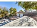 House exterior showcasing a curved driveway and landscaping at 8190 Sandy Creek Dr, Las Vegas, NV 89123