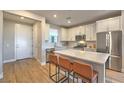 Modern kitchen with white cabinets, island, and stainless steel appliances at 92 Stone Bluff Ln, Henderson, NV 89011
