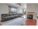 Relaxing living room with a large sectional sofa and fireplace at 10605 Moon Flower Arbor Pl, Las Vegas, NV 89144