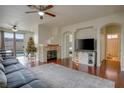 Bright living room with hardwood floors, fireplace, and view of backyard at 10605 Moon Flower Arbor Pl, Las Vegas, NV 89144