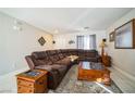 Living room features a sectional sofa and tile floors at 11193 Falesco Ave, Las Vegas, NV 89138