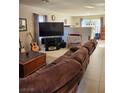 Living room with sectional sofa and entertainment center at 11193 Falesco Ave, Las Vegas, NV 89138