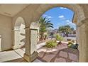 View through archway showing backyard access and neighborhood homes at 1647 Fieldbrook St, Henderson, NV 89052