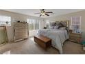 Spacious bedroom with large bed, dresser, and plenty of natural light at 2404 Briggsdale Ave, North Las Vegas, NV 89081