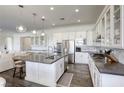 Modern kitchen with white cabinets and island at 2576 Desante Dr, Henderson, NV 89044