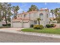 Inviting two-story home with a three-car garage, desert landscaping, and a red tile roof at 2617 Huber Heights Dr, Las Vegas, NV 89128