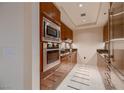 Modern kitchen with stainless steel appliances and wood cabinetry at 2700 Las Vegas Blvd # 2006, Las Vegas, NV 89109