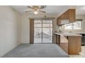 Bright dining area with sliding glass door to backyard and wood cabinets at 321 Carrington St, Henderson, NV 89074