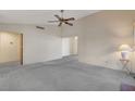 Spacious living room with gray carpeting and a ceiling fan at 321 Carrington St, Henderson, NV 89074