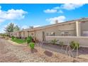 View of the property's backyard, featuring a stone pathway and neatly trimmed bushes at 3236 Mystic Ridge Ct, Las Vegas, NV 89129