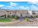 Backyard view showcasing a patio area, desert landscaping, and a gravel pathway at 3236 Mystic Ridge Ct, Las Vegas, NV 89129