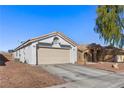 One-story house with light-colored exterior, two-car garage, and desert landscaping at 3327 Outlook Point St, North Las Vegas, NV 89032