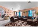 Spacious living room featuring a large sectional sofa and decorative wall accents at 3327 Outlook Point St, North Las Vegas, NV 89032