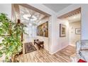 Bright and spacious entryway with wood-look tile floors and large artwork at 3918 Champagne Wood Dr, North Las Vegas, NV 89031