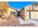 House exterior showcasing walkway to entrance and two-car garage at 3918 Champagne Wood Dr, North Las Vegas, NV 89031