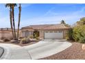 Single-story house with tan walls, tile roof, and a two-car garage at 4609 Snowpoint Ct, Las Vegas, NV 89130