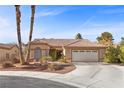 Single-story house with tan walls, tile roof, and a two-car garage at 4609 Snowpoint Ct, Las Vegas, NV 89130