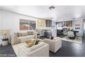 Open-concept living space features neutral tones, modern furnishings, and seamless flow to the kitchen and dining area at 4981 Alondra Dr, Las Vegas, NV 89118