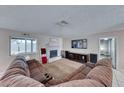 Spacious living room featuring a fireplace and comfortable seating at 5124 Brownwood Ave, Las Vegas, NV 89122