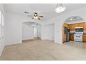 Open concept living and kitchen area with tile floors and archways at 5400 Flowing Spring St, Las Vegas, NV 89122