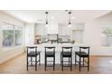 Modern kitchen featuring white shaker cabinets, quartz countertops, and a large island at 5904 Willowcreek Rd, North Las Vegas, NV 89031