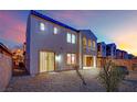 Backyard with gravel, a sliding glass door, and a partial view of neighboring houses at 624 Via Colmo Ave, Henderson, NV 89011