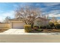 One-story home with a neutral color scheme and mature tree at 6436 Emerson St, Pahrump, NV 89048