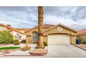 Single-story home with attached garage and well-manicured lawn at 7812 Desert Candle Way, Las Vegas, NV 89128