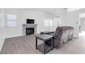 Bright living room with a fireplace, gray flooring and reclining sofa at 823 Crabapple Dr, Henderson, NV 89002