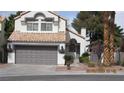 Charming two-story home featuring a gray two-car garage and a tile roof at 8416 Shore Breeze Dr, Las Vegas, NV 89128